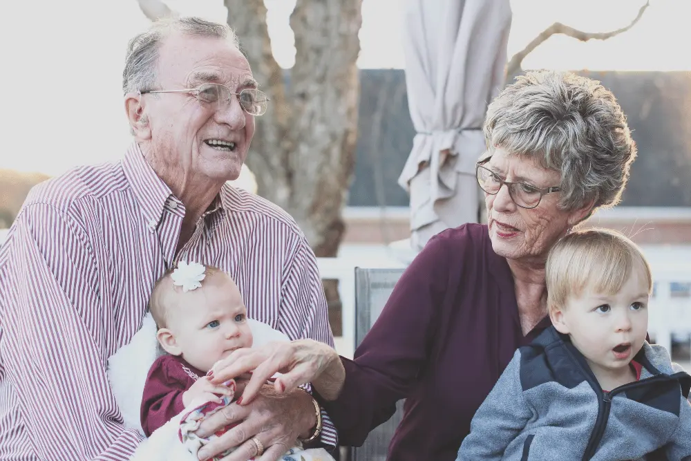 Image of two grandparents and an infant.